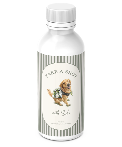 Custom 50ml mini-liquor shooter bottle wrapped in a personalized sage-striped label reading 'Take a Shot with Solo' with a golden retriever illustration and the drink recipe.