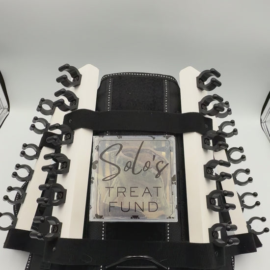 Personalizable acrylic tip jar attachments for the Solo Shot Saddle dog harness, secured with hook and loop and customized with the dog’s name and photo.